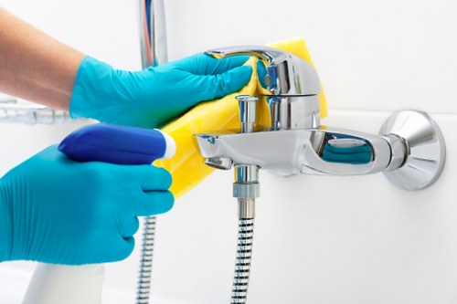 Local cleaner maintaining a Westminster apartment kitchen and living area