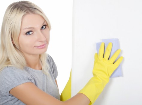 Local sofa cleaning technician treating stains on a living room sofa