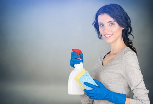 Trained Westminster cleaner using PPE while handling cleaning products